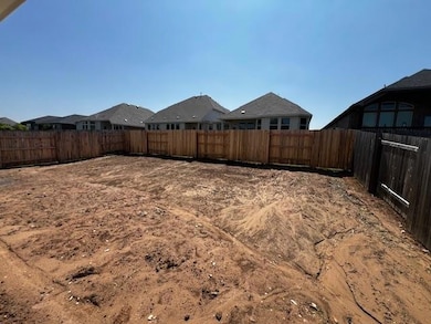 Fenced backyard featuring a residential view