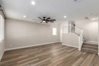 Empty room featuring stairway, light wood-style flooring, recessed lighting, and a ceiling fan