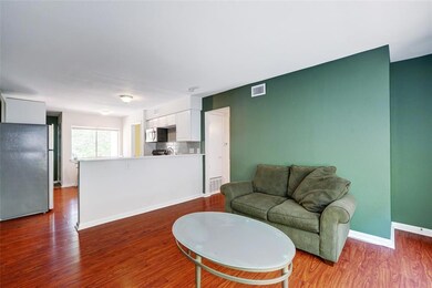 Living area with baseboards and wood finished flo