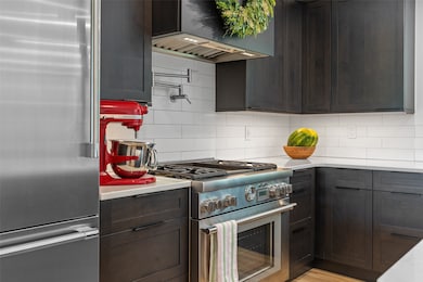 High quality Thermador gas range with water spigot for filling pots over range top and griddle in center with four burners