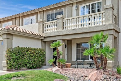 View of front of home featuring a balcony and stuc