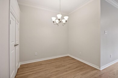 Empty room featuring a chandelier, light wood-type