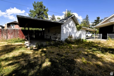 View of side of home with a patio area and a carport
