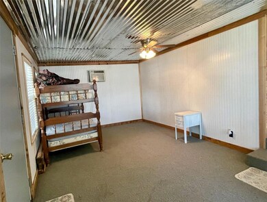 One side of den currently used a bunk space for ex