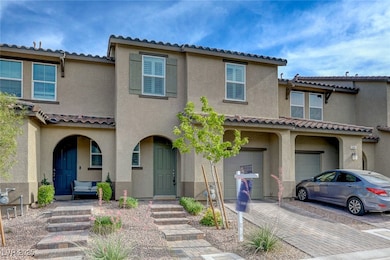 View of property with a tiled roof, a garage, driv