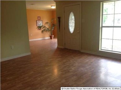 Living area open to dining room, wood laminate flo