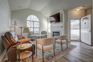 Living area with visible vents, lofted ceiling, wo