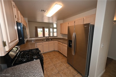 Kitchen with stainless steel appliances, a sink, l