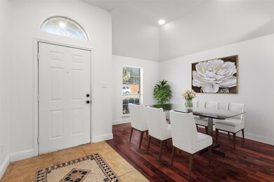 Virtually staged Dining room featuring dark hardwo