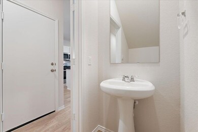 Bathroom with wood finished floors and a sink