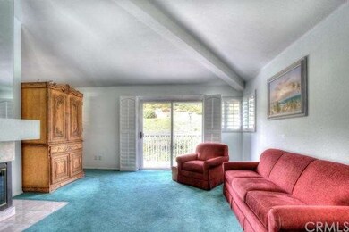 Family room opens to rear deck with hillside views