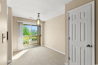 Carpeted empty room with baseboards and a textured