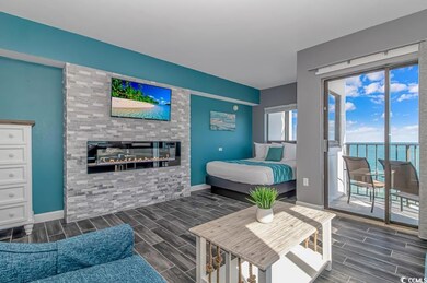 Bedroom featuring wood tiled floors, a fireplace, and access to outside