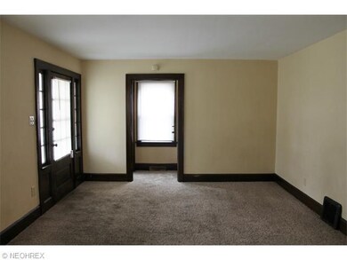 A spacious living room with newer carpet and fresh