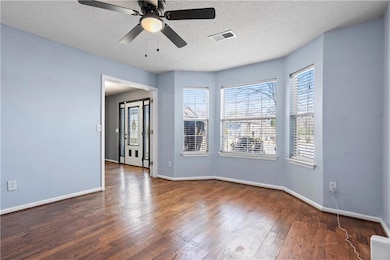 Spare room featuring a ceiling fan, wood finished 