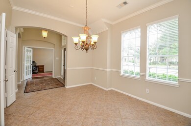 Architectural details and crown molding elevate this space.  Passage way into kitchen shown on the left side