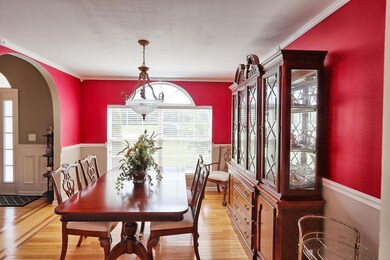Dining room features hardwood floors, chair rail and picture window.