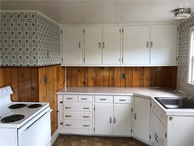 The kitchen with wood cabinets above...