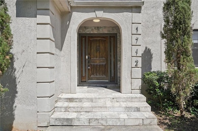 View of exterior entry with stucco siding