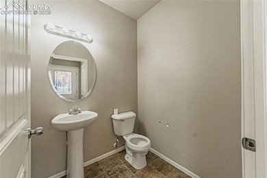 Bathroom with toilet and baseboards