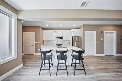 Kitchen featuring plenty of natural light, white cabinetry, backsplash, and recessed lighting