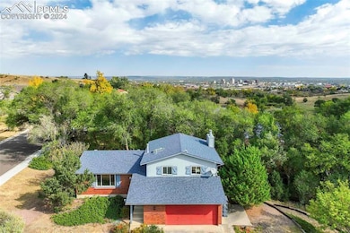 Front aerial view with Colorado Springs downtown i