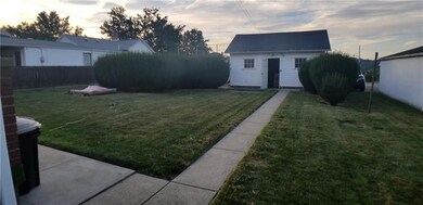Flat back yard with garage