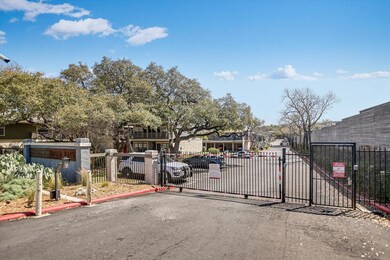 View of street with a gate, curbs, and a gated en