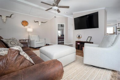 Living room with a ceiling fan, plenty of natural 