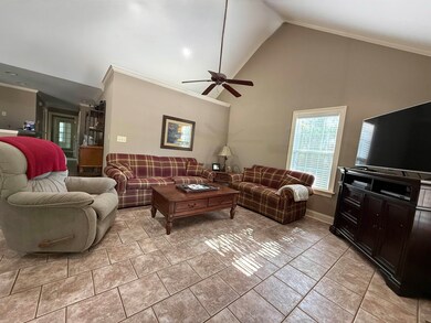 Living room featuring crown molding, high vaulted 
