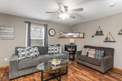 Living room featuring dark hardwood / wood-style floors and ceiling fan