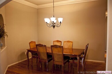 Large formal dining room has custom lighting, crow