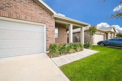 The attached garage sits atop a roomy, paved driveway.