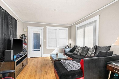 Living room featuring ornamental molding, a textur