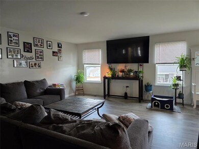 Living room with wood finished floors and baseboards