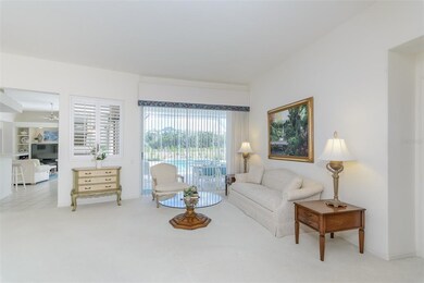 The formal living room has sliding glass doors tha