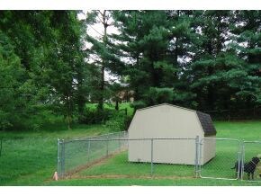 FENCED BACKYARD WSTORAGE BLDG