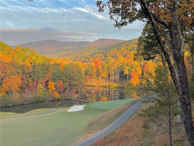 Fall Season view of lake, mountains, and golf cour