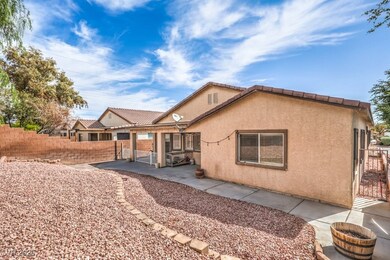 Rear view of property featuring fence, stucco sidi