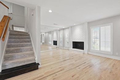 Unfurnished living room with visible vents, wood f