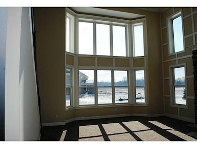 Great Room. Custom trim on feature wall with fireplace..and those windows! WOW!