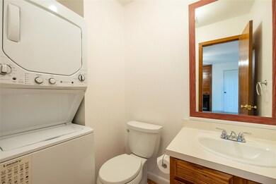 Bathroom featuring stacked washer / dryer, vanity