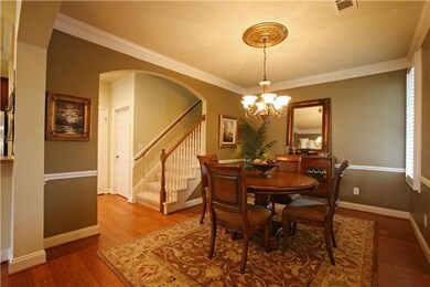 The Dining Room imbues elegance with arched entryways, crown molding, custom paint, gorgeous lighting and Plantation Shutters!