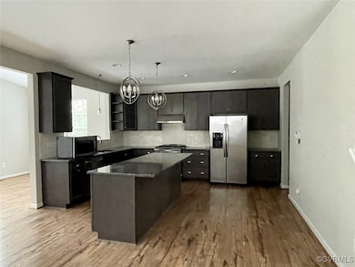 Kitchen with laminate wood-style flooring, granite