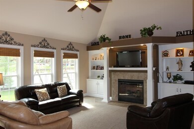 The spacious living room has an abundance of natur