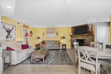 Living room with baseboards, a textured ceiling, v
