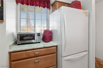 The Kitchen has white countertops and wood cabinet
