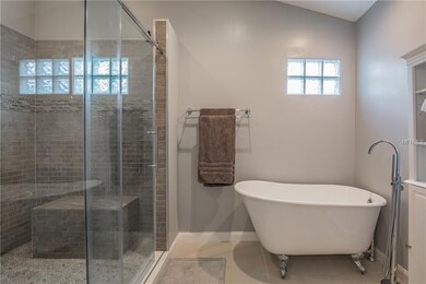 Glass walk-in shower with multiple spray heads and