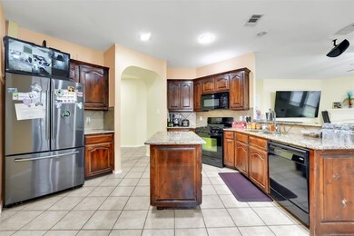 Kitchen featuring tasteful backsplash, light tile 
