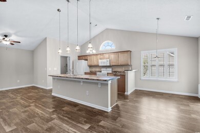Kitchen featuring pendant lighting, ceiling fan, a